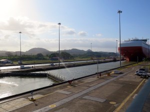 A large cargo ship passing through the Miraflores locks